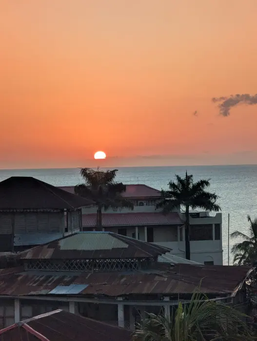 Orange sunset over the sea and Stone Town rooftops