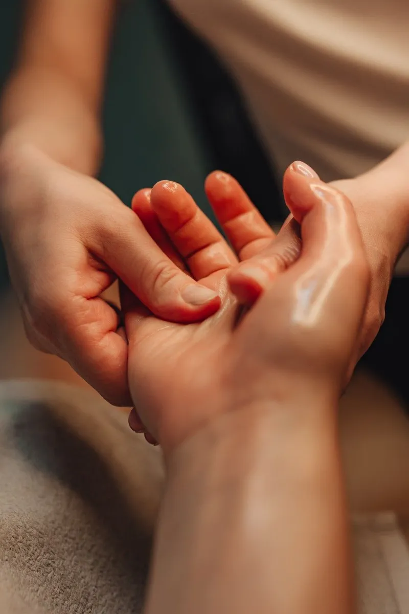 Therapist massaging the palm of a client's hand