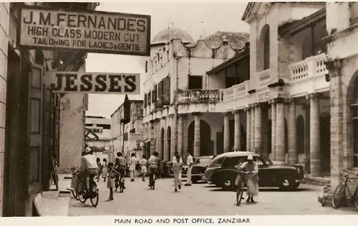 Vintage photo of Main Road and the Post Office, Zanzibar, with cyclists and old cars